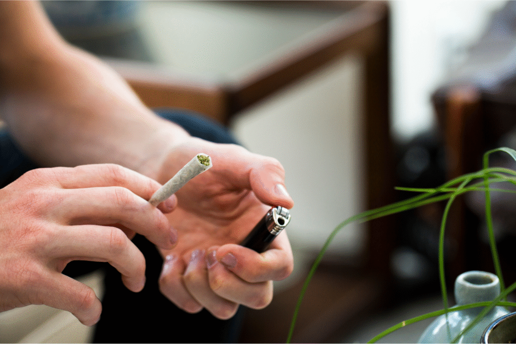 Man about to light a preroll outdoors