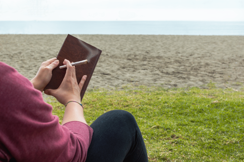 Person smoking a joint by the beach